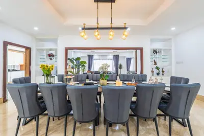a dining room with a table and chairs at Tropical Bliss Luxe 5BR 30Pax Private Pool Villa KL by Verano in Kuala Lumpur