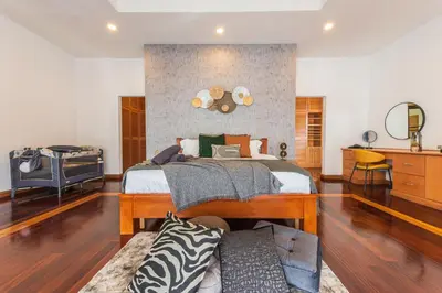 a bedroom with a large bed and a couch at Tropical Bliss Luxe 5BR 30Pax Private Pool Villa KL by Verano in Kuala Lumpur