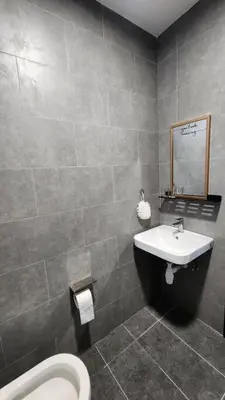 a bathroom with a toilet and a sink at The Nova by The City Collection in Kuala Lumpur