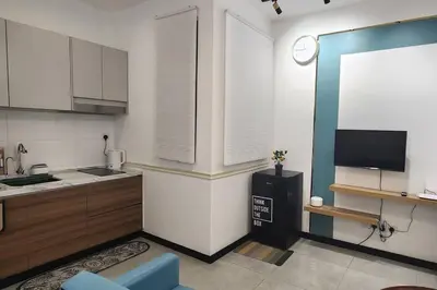 a kitchen with a counter and a tv in it at The Nova by The City Collection in Kuala Lumpur