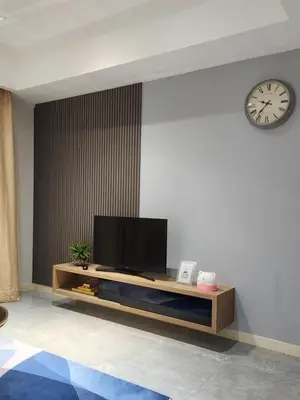 a living room with a tv and a clock on the wall at Mont Kiara The Ooak Suites & Residences l 1BR in Kuala Lumpur