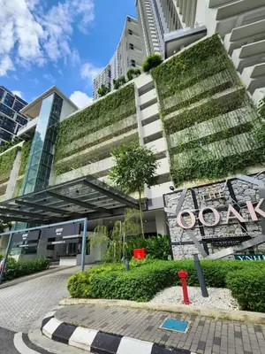 a building with a green wall on the side of it at Mont Kiara The Ooak Suites & Residences l 1BR in Kuala Lumpur