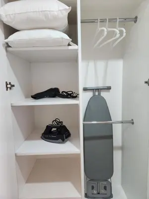 a room with a bed and a snowboard on shelves at Mont Kiara The Ooak Suites & Residences l 1BR in Kuala Lumpur