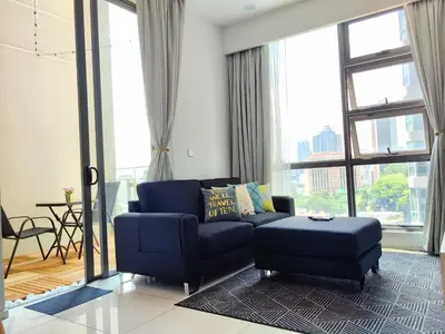 a living room with a blue couch and a stool at MyCrib13*The Robertson KL - Bukit Bintang Pavilion in Kuala Lumpur