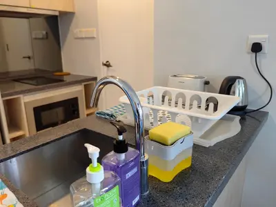 a kitchen sink with a dish drying rack next to it at MyCrib13*The Robertson KL - Bukit Bintang Pavilion in Kuala Lumpur