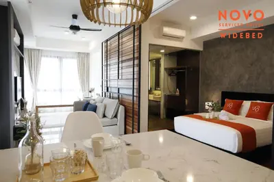 a hotel room with a bed and a living room at NOVO Serviced Suites by Widebed, Jalan Ampang, Gleneagles in Kuala Lumpur