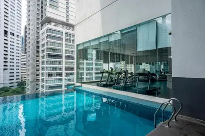 a swimming pool in a building with tall buildings at MyRehat Suites Bukit Ceylon in Kuala Lumpur