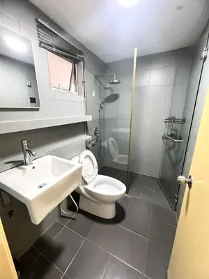 a bathroom with a toilet and a sink and a shower at Superb Maya Twin Tower View in Kuala Lumpur