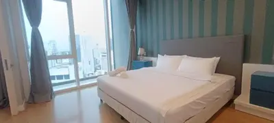 a white bed in a room with a large window at Sidemen Suites at Platinum KLCC in Kuala Lumpur