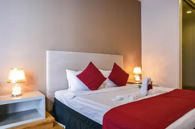 a bedroom with a large bed with red pillows at Sidemen Suites at Platinum KLCC in Kuala Lumpur