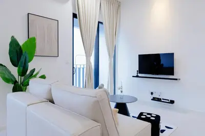 a living room with a white couch and a tv at The Pano Residence Jalan Ipoh Insta-worthy Bath Tub Studio \u6d74\u7f38MRT in Kuala Lumpur