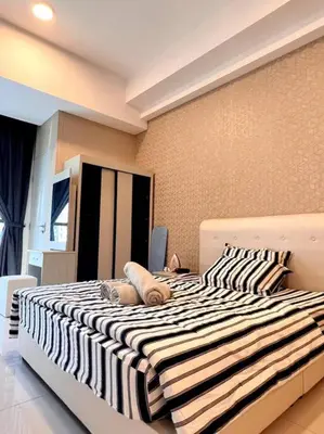 a bedroom with a large bed with a striped blanket at Seputeh Cozy & Homely VIVO Suite Old Klang Road Near MidValley, The Garden Mall in Kuala Lumpur
