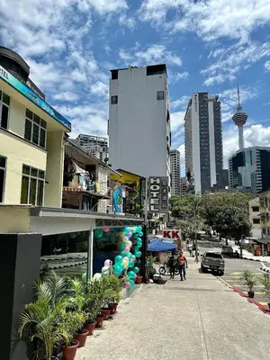 a street in a city with a building and plants at Hotel MSP Bukit Bintang in Kuala Lumpur
