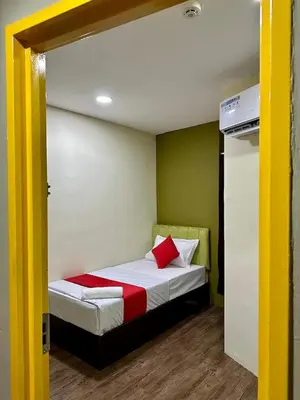 a bedroom with a bed with red and white sheets at Hotel MSP Bukit Bintang in Kuala Lumpur