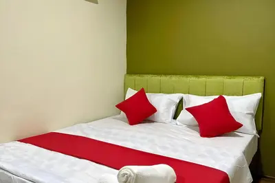 a bedroom with a bed with red and white pillows at Hotel MSP Bukit Bintang in Kuala Lumpur