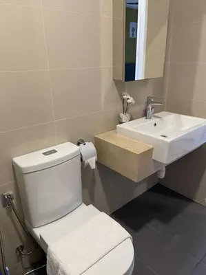a bathroom with a white toilet and a sink at Cozy Family Suite Kepong DesaPark MontKiara Publika Mitec in Kuala Lumpur