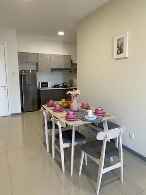 a kitchen with a table with pink dishes on it at Cozy Family Suite Kepong DesaPark MontKiara Publika Mitec in Kuala Lumpur