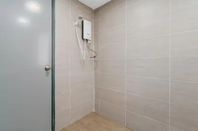 a shower with a glass door in a bathroom at Plaza Berjaya Apt Bukit Bintang With Foosball in Kuala Lumpur