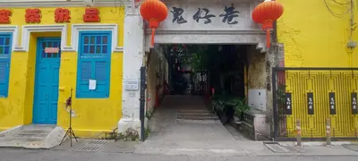 an entrance to a yellow building with blue doors at Plaza Berjaya Apt Bukit Bintang With Foosball in Kuala Lumpur