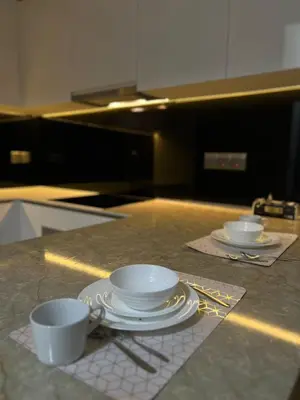 two cups and saucers sitting on a kitchen counter at Star Residence Apartment with High Kuala Lumpur view in Kuala Lumpur