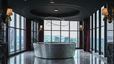 a lobby with a large round table in front of windows at Star Residence Apartment with High Kuala Lumpur view in Kuala Lumpur