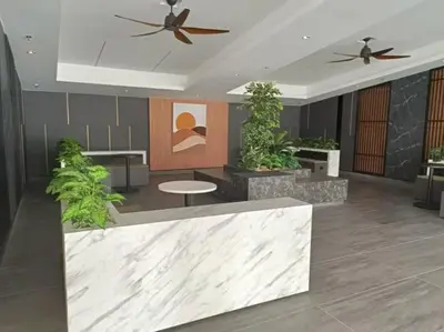 a lobby with a table and a ceiling fan at Muji Style, Inspirasi Residences Mont Kiara in Kuala Lumpur