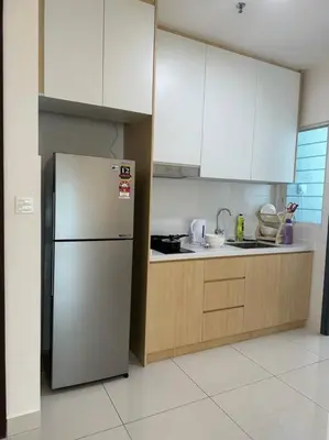 a kitchen with a stainless steel refrigerator and cabinets at Muji Style, Inspirasi Residences Mont Kiara in Kuala Lumpur