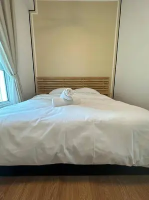 a white bed with a towel on top of it at Muji Style, Inspirasi Residences Mont Kiara in Kuala Lumpur