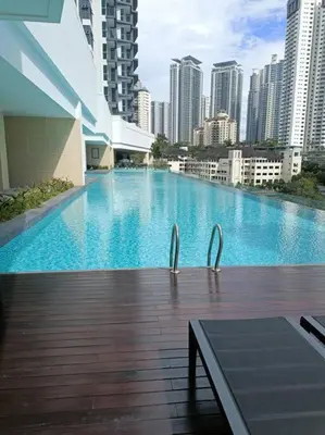 a large swimming pool in a city with tall buildings at Muji Style, Inspirasi Residences Mont Kiara in Kuala Lumpur
