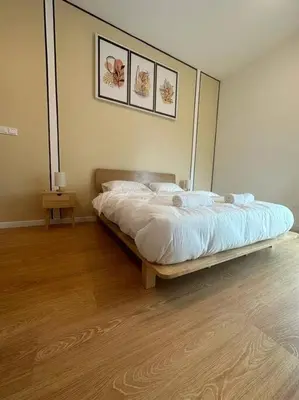 a bedroom with a bed and a wooden floor at Inspirasi Residences Mont Kiara muji house in Kuala Lumpur