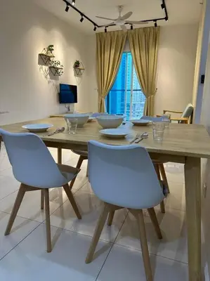 a dining room with a wooden table and chairs at Inspirasi Residences Mont Kiara muji house in Kuala Lumpur