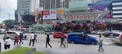 a group of people crossing a busy city street at Plaza Berjaya Apt Bukit Bintang with Pool Table in Kuala Lumpur