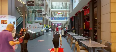 a group of people walking through a shopping mall at Plaza Berjaya Apt Bukit Bintang with Pool Table in Kuala Lumpur
