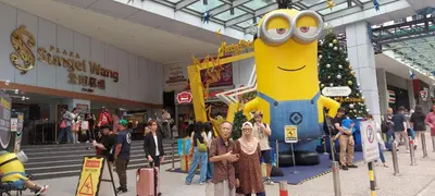 a group of people standing in front of a large minion statue at Plaza Berjaya Apt Bukit Bintang with Pool Table in Kuala Lumpur