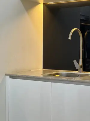 a kitchen with white cabinets and a sink at Star Residence Apartment with twin towers KLCC view in Kuala Lumpur