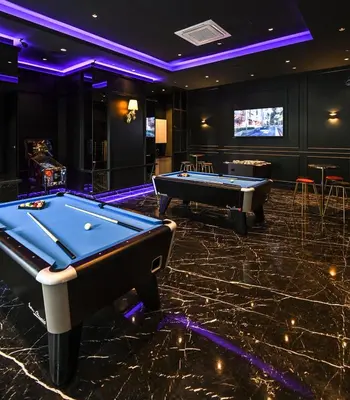 a billiard room with two pool tables and a screen at Star Residence Apartment with twin towers KLCC view in Kuala Lumpur