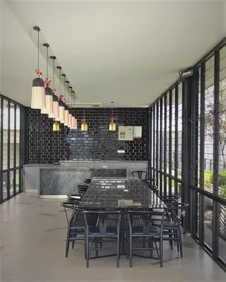 a dining room with a table and chairs and windows at KL Serenity Quarter Flexus at Jln Kuching - Self C-In, F-Parking in Kuala Lumpur
