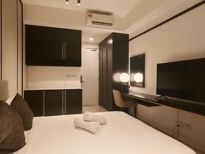 a hotel room with a bed and a television at The Axon Bukit Bintang by SMOVF BNB in Kuala Lumpur
