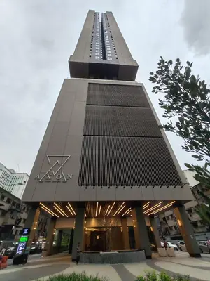 a large building with a tall tower in a city at The Axon Bukit Bintang by SMOVF BNB in Kuala Lumpur