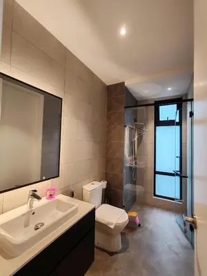 a bathroom with a sink and a toilet and a mirror at The Axon Bukit Bintang by SMOVF BNB in Kuala Lumpur