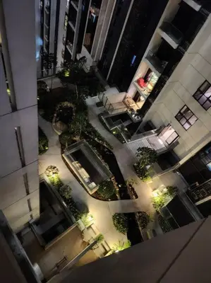 an overhead view of a building with a courtyard with plants at M City Minimalist KLCC Suite in Kuala Lumpur