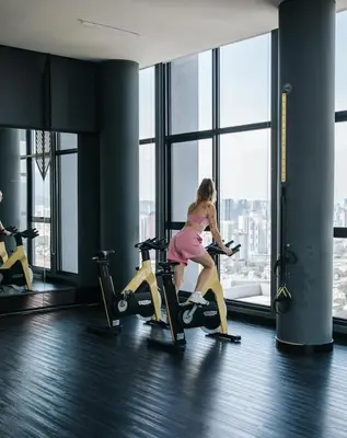 a woman riding on a treadmill in a gym at Expressionz Leisure Suites KLCC in Kuala Lumpur
