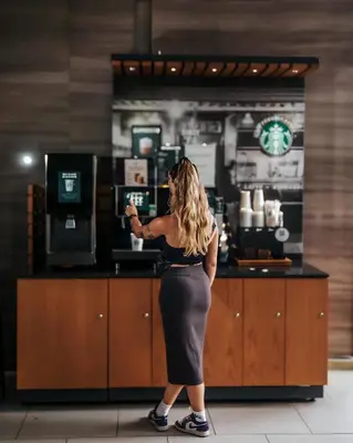 a woman is standing in front of a counter at Expressionz Leisure Suites KLCC in Kuala Lumpur