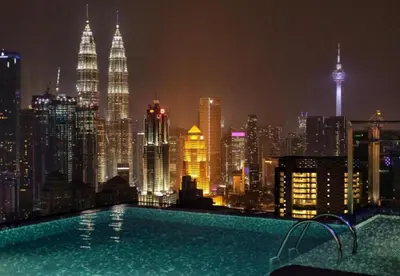 a swimming pool on the roof of a building with a city skyline at Expressionz Leisure Suites KLCC in Kuala Lumpur