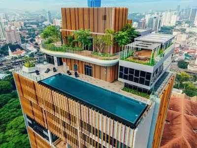 a building with a swimming pool on top of it at Ceylonz Leisure Suites KLCC Bukit Bintang in Kuala Lumpur
