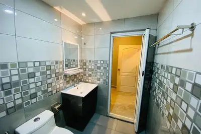 a bathroom with a toilet and a sink and a mirror at Hotel Dlima Inn Bukit Bintang in Kuala Lumpur