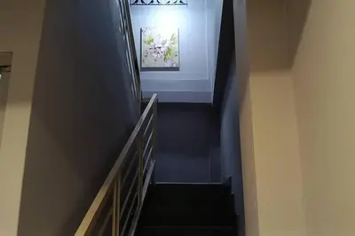 a hallway with a staircase with blue walls and a stair case at Hotel Dlima Inn Bukit Bintang in Kuala Lumpur