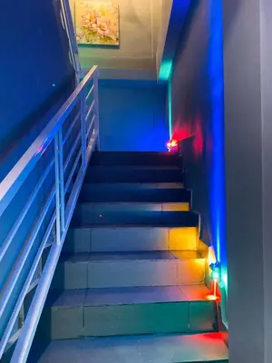 a staircase with blue and green lights on it at Hotel Dlima Inn Bukit Bintang in Kuala Lumpur