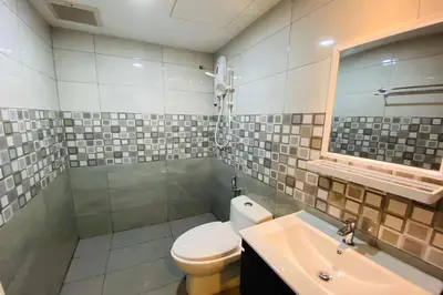 a bathroom with a toilet and a sink at Hotel Dlima Inn Bukit Bintang in Kuala Lumpur