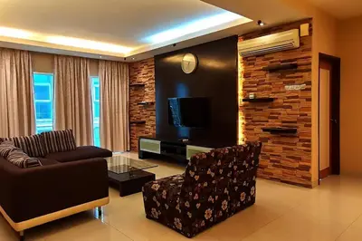 a living room with a couch chair and a television at KLCC Luxurious 2 Floors Homestay 5BR for 15pax in Kuala Lumpur
